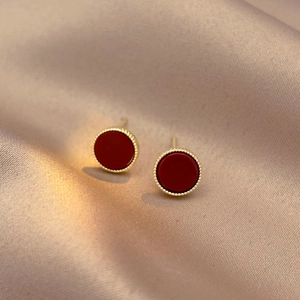 Retro red geometric round stud earrings with gold beaded edges on silk background