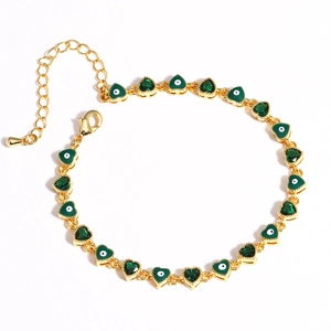 Detail of gold chain bracelet with green heart charms and evil eye enamel design