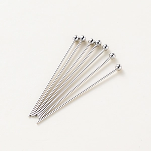 Macro detail of eight polished steel ball headpins for DIY jewelry making on white background