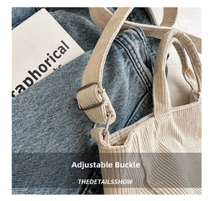 Detail shot of the silver metal adjustable buckle on the beige corduroy tote bag strap