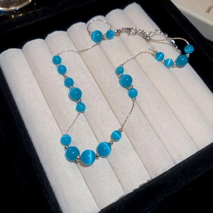 Detail of blue cat eye stone bead necklace with silver adjustable lobster clasp