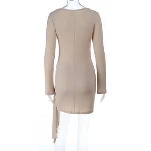 Detail of apricot textured fabric and side flowing ribbon on a slim-fit evening dress