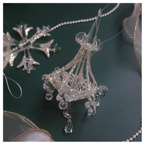 Close-up of glass Christmas snowflake ball with silver glitter and crystal pendants
