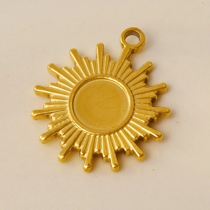 Macro shot of gold sun-shaped pendant with polished 304 stainless steel metal finish