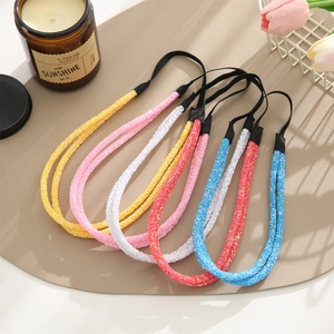 Detail of six colorful glitter headbands with elastic bands and sparkling sequins fabric