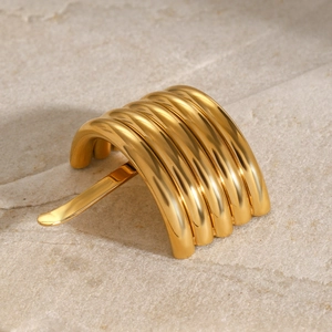 Detailed view of the layered gold metal hair fork pin with a high-shine polished finish
