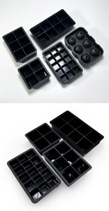 Macro view of various black silicone ice cube trays and sphere molds set