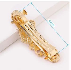 Detailed back view of a 6.8cm gold star and moon hair clip with a sturdy spring mechanism
