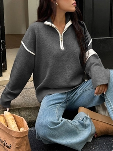 Women casual grey half-zip sweater with white sleeve stripes shown in outdoor street style