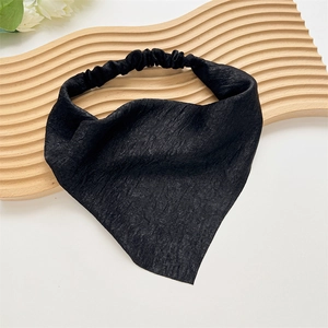 Detail of black pleated fabric triangle bandana with elastic band on wooden stand