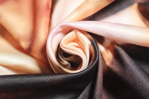Macro shot of high-density knit fabric with angel print and spiral texture detail