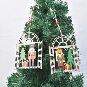 Hollow wood Christmas Nutcracker ornament hanging on a festive green pine tree