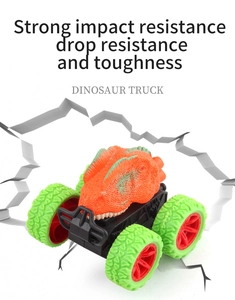 Detail of orange dinosaur truck showing shockproof frame and large non-slip tires