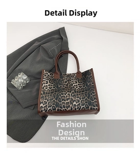 Detail showing leopard print tote bag with brown leather handles and a spacious square shape