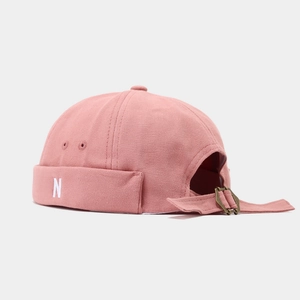 Detail of pink canvas miki hat featuring white letter N embroidery and metal eyelets