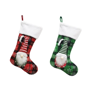Christmas stockings featuring gnome dolls and snowflake patterns on red and green plaid fabric