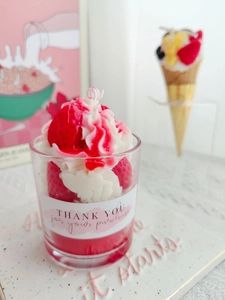 Detail of strawberry cream scented candle in glass jar with thank you label