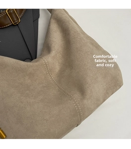 Detail view of suede tote bag with reinforced double stitching and leather strap