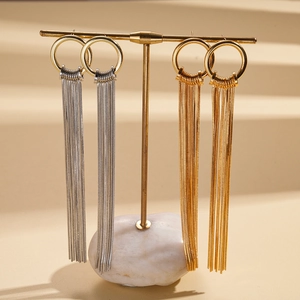 18K gold and silver plated long tassel earrings on a minimalist display stand