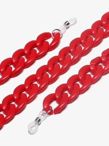 Detailed macro view of red acrylic eyeglass chain with silver rings and silicone loops