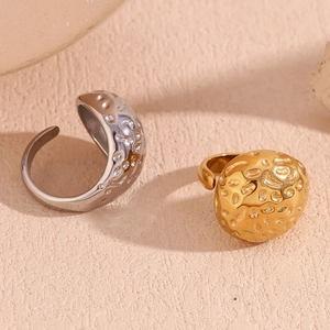 Hammered texture open teardrop rings in 18K gold and silver finish on pink background