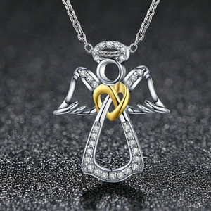 Detailed close-up of a silver angel pendant necklace with crystal wings and golden heart knot