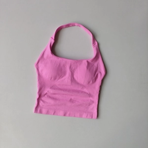 Flat lay of pink halter neck sports crop top with seamless ribbed texture and chest pads