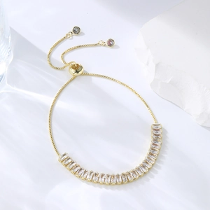 Macro view of adjustable gold box chain with baguette-cut sparkling zircon stones