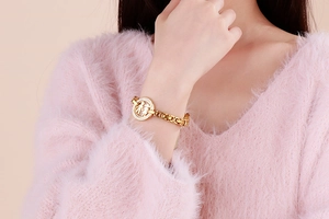 Gold stainless steel thick link bracelet with hollow pavé boy girl charm on model
