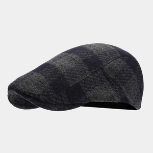 Close-up of retro grey and blue checkered wool fabric texture on a flat cap