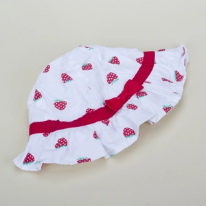 Dettaglio cappello sole neonato con stampa fragole e fiocco rosso su tesa bianca