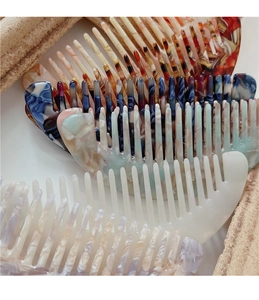 Close-up of colorful acetate mini hair combs with marble and tortoiseshell patterns