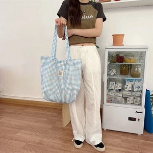 Blue plaid canvas tote bag detail featuring cute bow print and spacious interior design