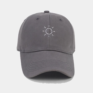 Detailed view of the white sun embroidery on a high-density cotton grey baseball cap