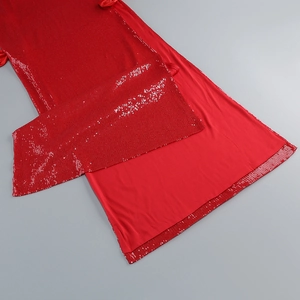 Detailed close-up of red sequin embroidery and smooth inner lining on evening dress