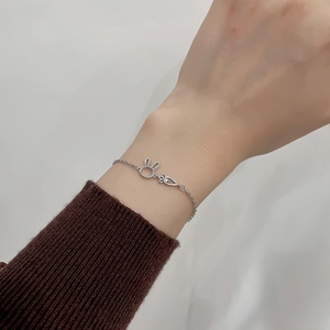 Silver bracelet with hollow rabbit and carrot charms worn on a wrist for daily fashion
