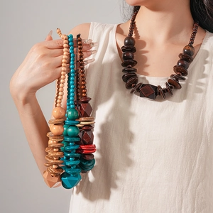 Detailed view of handmade wood and coconut shell beaded necklaces in diverse natural colors