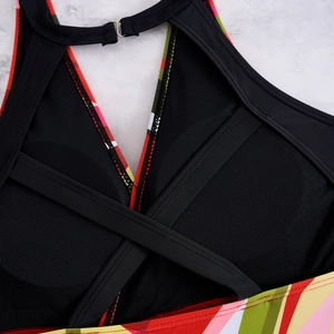Detail of cross-back straps and breathable mesh on a floral print tankini swim top