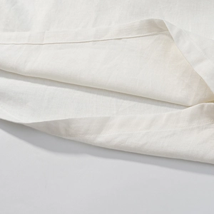Detail of white cotton linen fabric showing the high-quality stitching and breathable texture