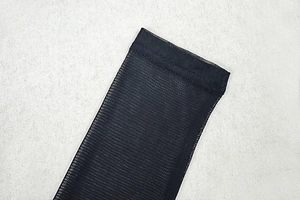 Close-up of black mesh sleeve detail with precise stitching and breathable texture