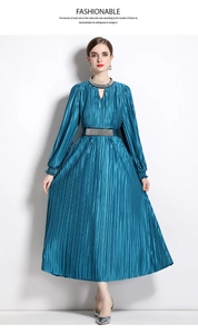 Detailed view of luxury turquoise pleated maxi dress with elegant beadwork and rhinestones