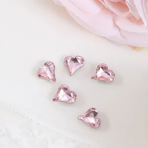 Macro shot of 8x9mm pink heart-shaped crystal nail charms with fine faceted cuts