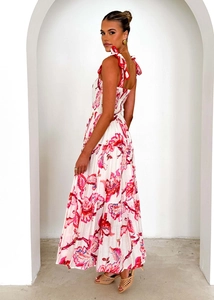 Detailed view of red floral maxi dress featuring tie-up ribbon straps and smocked bodice