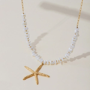 Detail of starfish pendant necklace with irregular white beads and gold chain