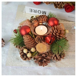 Detail of pine cone Christmas candle holder with glass cup and white wax on snow