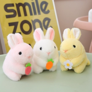 Plush pull-string rabbit toys in pink, white, and yellow holding strawberry and carrot