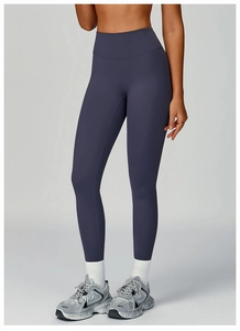 Close-up of high-waist purple yoga leggings with seamless elastic fabric for fitness