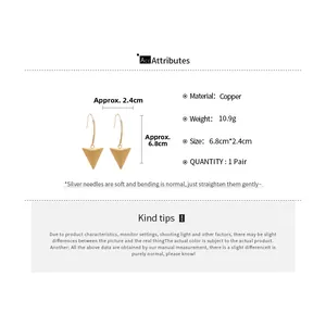 Detail view of 18k gold plated triangle drop earrings showing 6.8cm size and copper material