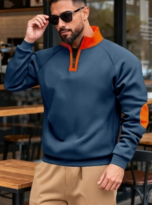 Detail view of navy fleece sweatshirt with orange collar lining and outdoor casual style
