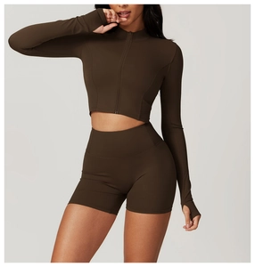 Detailed view of coffee brown fitness set featuring thumbhole sleeves and high waist shorts